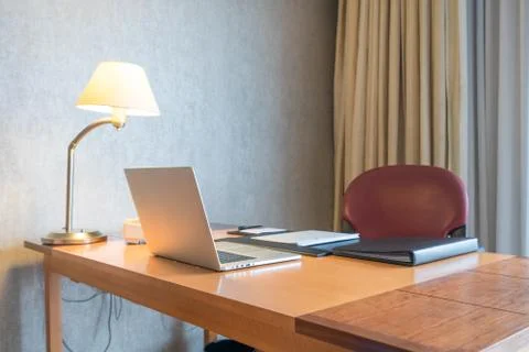 Computer display and office tools on desk in home. Desktop computer screen is Stock Photos