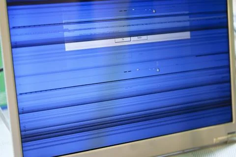 Computer display with blue striped screen showing malfunction. Stock Photos