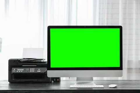 Computer display with chroma key on desk in room. Comfortable workplace Stock Photos
