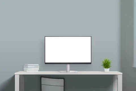 Computer display mockup on work desk with books and plant Stock Photos