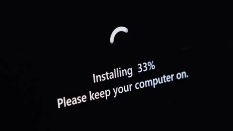 Computer display shows software installation progress at 33 percent, with a.. Stock Footage 314389090