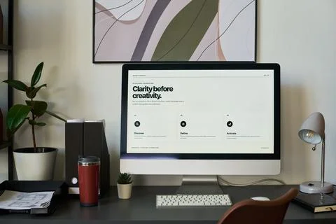 Computer Displaying Brand Strategy Design in Creative Studio Workspace Stock Photos