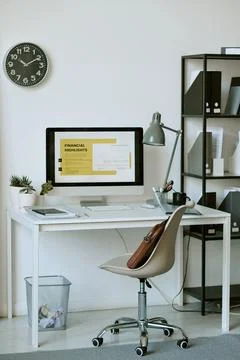Computer Displaying Financial Report on Desk in Modern Office Stock Photos