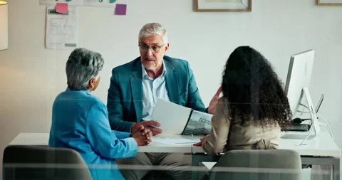 Computer, documents and meeting with business people in office together for Stock Footage 313576825
