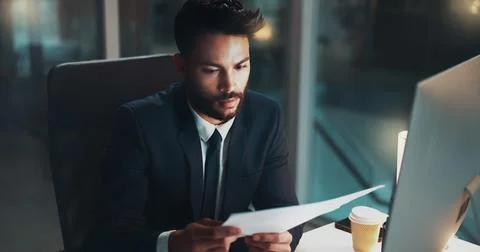Computer, documents and night with business man at desk in office for Stock Photos