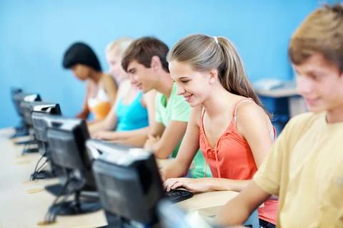 Computer, education and smile with students in classroom for learning, lect.. Stock Photos