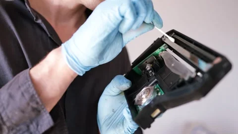 Computer engineer cleans printer cartridge with cotton swab and alcohol Stock Footage 275597711