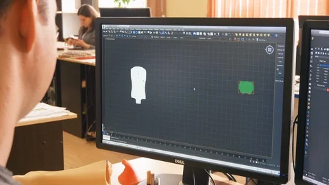 Computer engineer creates technological detail on computer Stock Footage 121224216