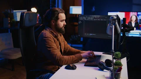 Computer engineer deliberating ways of fixing errors while developing code Stock Footage 265506379