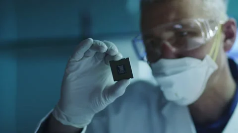 Computer Engineer is Holding and Inspecting Processor Chip Stock Footage 48402581