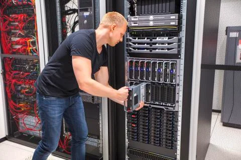Computer Engineer Installing Blade Server In Datacenter Stock Photos