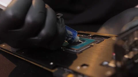 A computer engineer places thermal grease on a central processor of PC Stock Footage 154699790