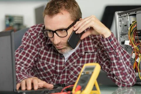 Computer engineer repairing broken desktop Stock Photos