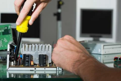 Computer engineer repairing hardware with screw driver Stock Photos