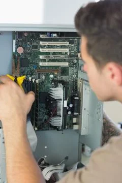Computer engineer repairing open computer with pliers Stock Photos