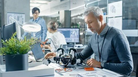 Computer Engineer in Robotics Branch Room, Works with Robot Coding Stock Photos