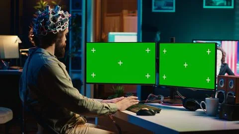 Computer engineer starting mind upload process using green screen PC Stock Photos