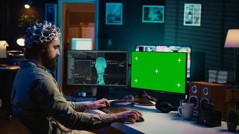 Computer engineer starting mind upload process using green screen PC Stock Photos