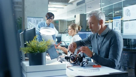 Computer Engineer Walks Into Robotics Branch Room, Talks With Specialists Stock Footage 85769024