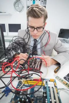 Computer engineer working on broken cables Stock Photos