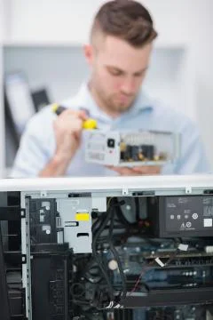 Computer engineer working on cpu part in front of open cpu Foto stock