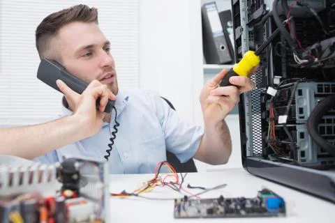 Computer engineer working on cpu while on call Stock Photos