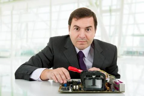 Computer Engineer working in a motherboard, at the office Stock Photos