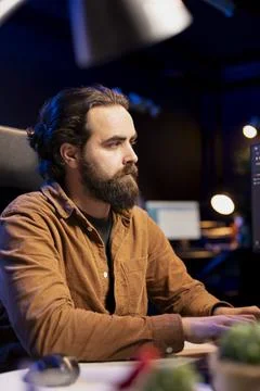 Computer engineer writing code to futureproof company network from downtimes Stock Photos