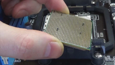 Computer engineer's hand holds a computer processor. Replacing components in a Stock Footage 145411317