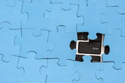 Computer Enter key under jigsaw puzzle Stock Photos