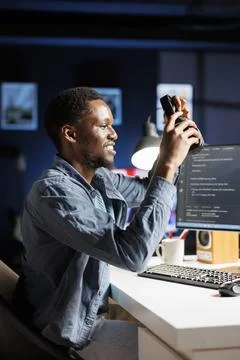 Computer expert encodes html scripts while enjoying music Stock Photos