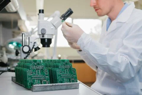 Computer expert professional technician examining board computer in a laboratory Stock Photos