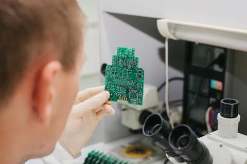 Computer expert professional technician examining board computer in a laboratory Foto stock