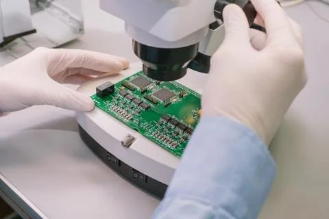 Computer expert professional technician examining board computer in a laboratory Stock Photos