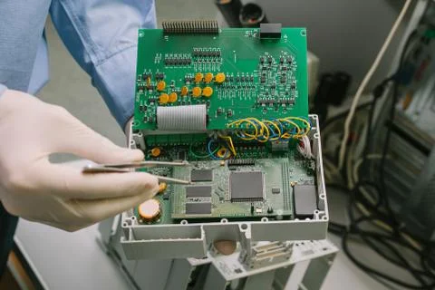 Computer expert professional technician examining board computer in a laboratory Foto stock