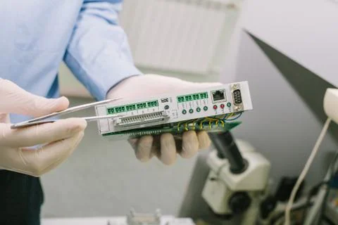 Computer expert professional technician examining board computer in a laboratory Stock Photos
