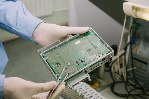 Computer expert professional technician examining board computer in a laboratory Stock Photos