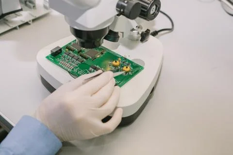 Computer expert professional technician examining board computer in a laboratory Stock Photos