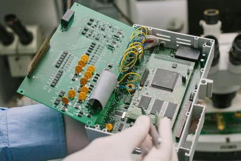 Computer expert professional technician examining board computer in a laboratory Foto stock