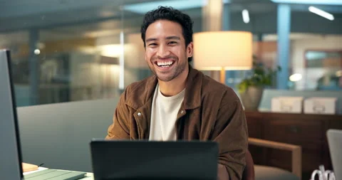 Computer, face and laughing with designer man at desk in dark office for Stock Footage 322569925