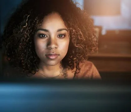 Computer, face and night with black woman programmer in office for web 写真素材