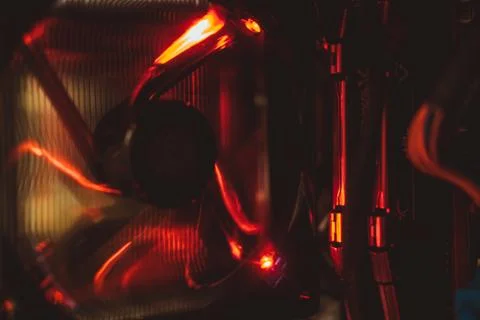 Computer fan and electronic components in red light from inside the tower. Stock Photos