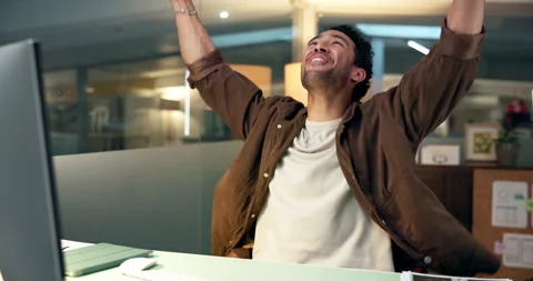 Computer, fist pump and night with designer man at desk in office for project Stock Footage 322569363