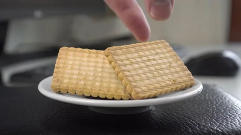 Computer freelance workplace with shortbread cookies in a saucer 動画素材 160265945