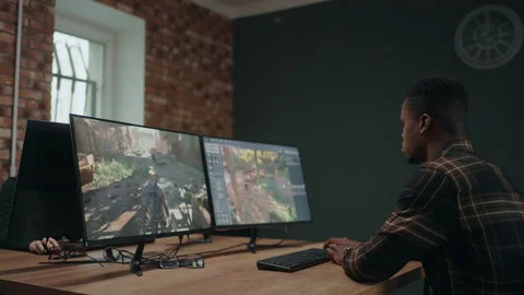 Computer game developer creating new interface for game, african american man Stock Footage 233719096