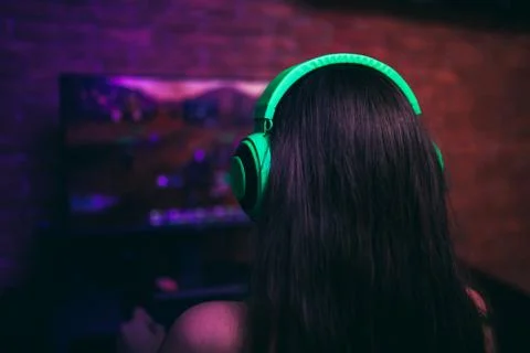 Computer games, playing place, young gamer playing video games with headphone Stock Photos