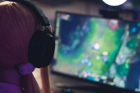 Computer games, playing place, young gamer playing video games with headphones Stock Photos