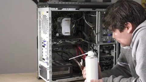 A Computer Geek Boy Cleaning Computer With Compressed Air.Servicing a equipme Stock Footage 85114205