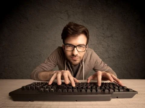 Computer geek typing on keyboard 스톡 사진