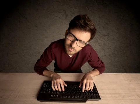 Computer geek typing on keyboard 스톡 사진